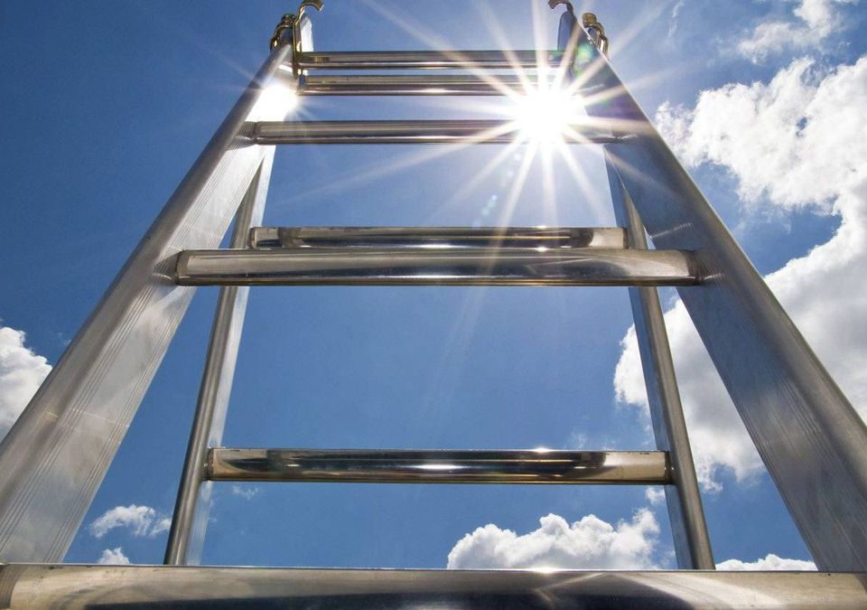 A ladder in the middle of day with clouds above