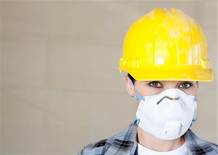 Portrait of female worker wearing dust mask